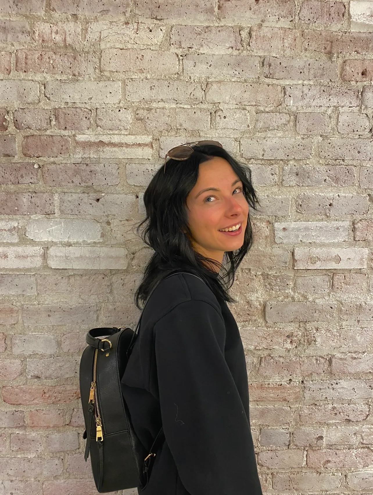 Portrait of creator Gabrielle Judge with sunglasses and a backpack