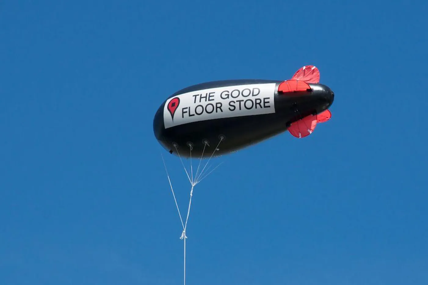 Blimp with an advertisement for The Good Floor Store.