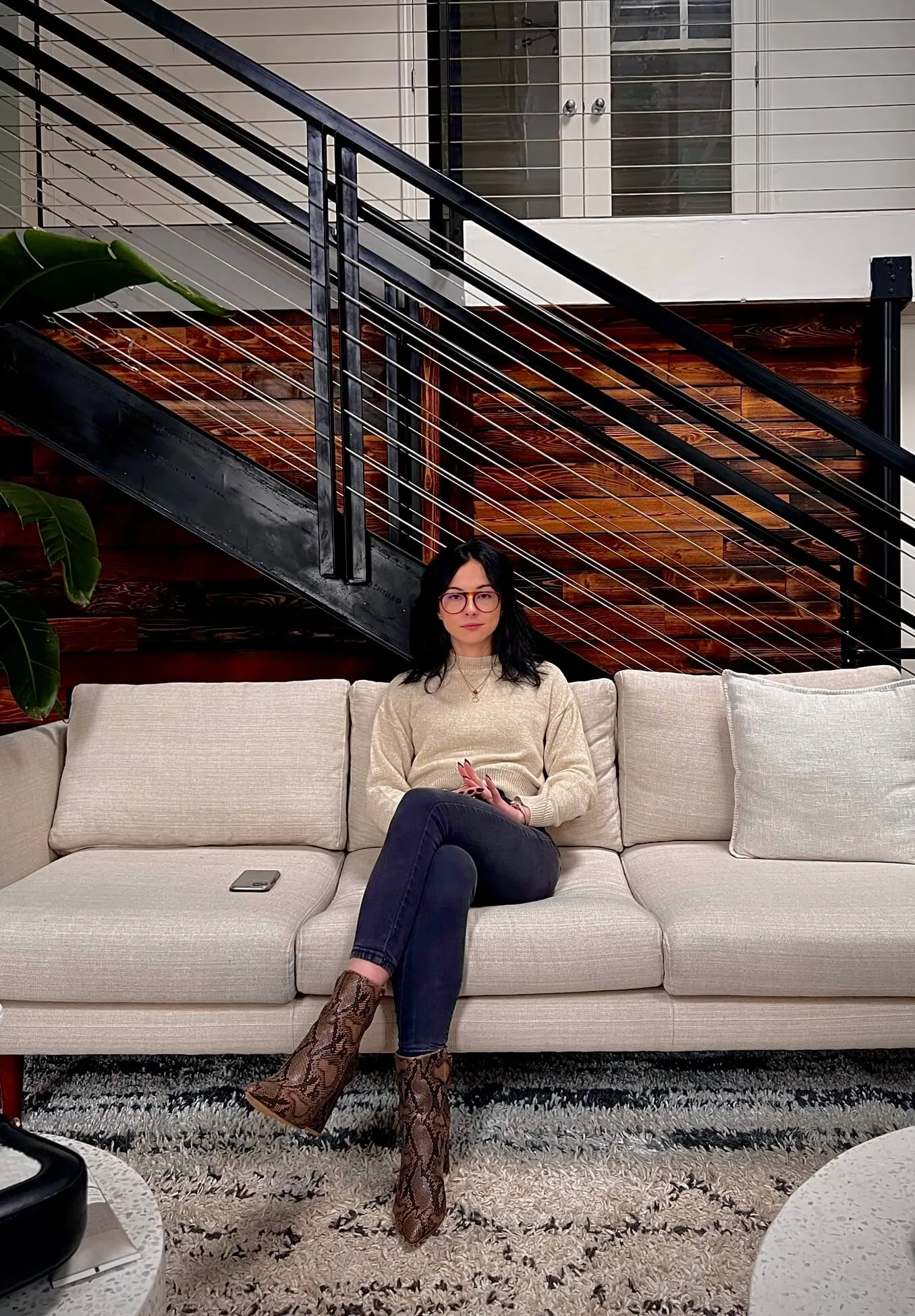 Portrait of TikTok creator and entrepreneur Gabrielle Judge sitting on a couch